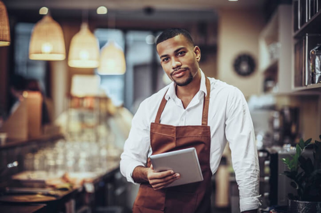 Restaurant owner or manager with tablet